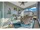 Relaxing screened porch with wicker furniture and ceiling fan at 8958 Sw 57Th Place Rd, Ocala, FL 34481