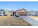 Tan house with brown garage door and brick driveway at 9119 Sw 70Th Loop, Ocala, FL 34481