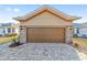 One story house with brown garage door and stone accents at 9119 Sw 70Th Loop, Ocala, FL 34481