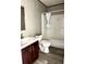 Bathroom with modern vanity, wood-look flooring, toilet, and shower-tub combo at 9160 Sw 31St Avenue Rd, Ocala, FL 34476