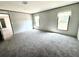 An ample bedroom with soft grey carpeting and two windows allows for natural light to illuminate the space at 9160 Sw 31St Avenue Rd, Ocala, FL 34476
