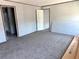 Open bedroom featuring soft carpet, neutral walls, and closet for storage at 9160 Sw 31St Avenue Rd, Ocala, FL 34476