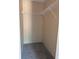 Carpeted walk-in closet with a single, white wire shelving unit for efficient storage at 9160 Sw 31St Avenue Rd, Ocala, FL 34476