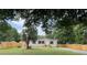 Charming home featuring a front yard, a wooden fence, and a well-maintained lawn at 9160 Sw 31St Avenue Rd, Ocala, FL 34476