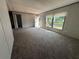 Bright living room features neutral walls, plush carpet, and abundant natural light from a set of windows at 9160 Sw 31St Avenue Rd, Ocala, FL 34476