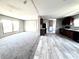 Spacious living room featuring carpet, wood-look flooring, and natural light from large windows at 9160 Sw 31St Avenue Rd, Ocala, FL 34476