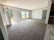 Bright living room features neutral walls, plush carpet, and abundant natural light from a set of windows at 9160 Sw 31St Avenue Rd, Ocala, FL 34476