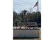 Attractive Southgate sign with an American flag waving overhead with pretty red and white flowers at 9160 Sw 31St Avenue Rd, Ocala, FL 34476