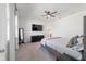 Spacious bedroom with large TV, dresser, and ceiling fan at 9780 Sw 42Nd Ave, Ocala, FL 34476