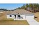 Single-story home with a gray roof, white walls, and a two-car garage at 9780 Sw 42Nd Ave, Ocala, FL 34476