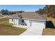 Newly constructed home with a gray roof and white exterior at 9780 Sw 42Nd Ave, Ocala, FL 34476