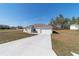 Single-story house with a long driveway and grassy front yard at 9780 Sw 42Nd Ave, Ocala, FL 34476