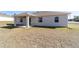 Rear view of house showing covered patio and yard at 9780 Sw 42Nd Ave, Ocala, FL 34476