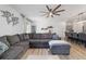 Living room with L-shaped sectional sofa and ceiling fan at 9780 Sw 42Nd Ave, Ocala, FL 34476