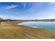 Scenic backyard view of the water, with a line of houses in the distance at 9858 Sw 75Th Street Rd, Ocala, FL 34481