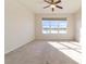 Bright bedroom with carpet, ceiling fan and large window overlooking a tranquil waterfront at 9858 Sw 75Th Street Rd, Ocala, FL 34481