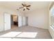 Light-filled bedroom with a ceiling fan, carpet flooring, and connected to the Primary bath at 9858 Sw 75Th Street Rd, Ocala, FL 34481