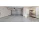 Spacious two-car garage featuring clean floors, shelving for storage, and an automatic door opener at 9858 Sw 75Th Street Rd, Ocala, FL 34481