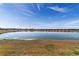 Picturesque view of the lake reflecting the clear blue sky, surrounded by lush landscaping at 9858 Sw 75Th Street Rd, Ocala, FL 34481