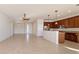 Spacious living room featuring tile flooring, modern lighting, and an open layout to the kitchen at 9858 Sw 75Th Street Rd, Ocala, FL 34481