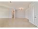 Bright living room with tile flooring and neutral walls, illuminated by a hanging light fixture at 9858 Sw 75Th Street Rd, Ocala, FL 34481