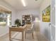 Bright home office featuring a wooden desk, bookshelf, and a view to the outside at 9858 Sw 75Th Street Rd, Ocala, FL 34481