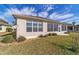 Exterior view of sunroom shows lush lawn and manicured landscaping at 9858 Sw 75Th Street Rd, Ocala, FL 34481