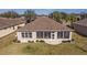 Wide angle view of backyard and home with sunroom and manicured lawn at 9858 Sw 75Th Street Rd, Ocala, FL 34481