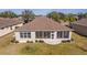 Wide angle aerial view of backyard, home with sunroom, and manicured lawn at 9858 Sw 75Th Street Rd, Ocala, FL 34481