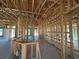 Interior view of new construction featuring wood framing and exposed ductwork, offering a glimpse into its structural design at 10 Spruce Pass, Ocala, FL 34472