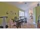 Rustic farmhouse dining room with a wooden table and green walls at 10170 Se 106Th Ln, Belleview, FL 34420