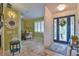 Spacious entryway, featuring a blue door and decorative mirror at 10170 Se 106Th Ln, Belleview, FL 34420