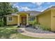 Charming yellow house with a landscaped front yard at 10170 Se 106Th Ln, Belleview, FL 34420