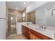 Bathroom boasts double vanity and walk-in shower at 10277 Sw 96Th Loop, Ocala, FL 34481