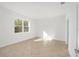 Bright, tile floored bedroom filled with natural light from a large window at 10306 Sw 99Th Ln, Ocala, FL 34481