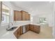 Bright kitchen featuring tile flooring, stainless steel appliances, and a large window over the sink at 10306 Sw 99Th Ln, Ocala, FL 34481