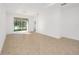 Bright living room with tile flooring and sliding glass doors to the screened in lanai at 10306 Sw 99Th Ln, Ocala, FL 34481