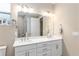 Modern bathroom featuring double sinks and a large mirror at 10339 Sw 96Th Ln, Ocala, FL 34481