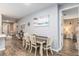 Dining area with farmhouse table and view into another room at 10339 Sw 96Th Ln, Ocala, FL 34481