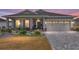 Single-story home with gray exterior, paver driveway, and landscaped yard at 10339 Sw 96Th Ln, Ocala, FL 34481