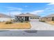 Single story home with gray exterior, paver driveway, and landscaped yard at 10339 Sw 96Th Ln, Ocala, FL 34481