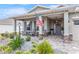 Front porch with rocking chairs, stone accents, and landscaping at 10339 Sw 96Th Ln, Ocala, FL 34481