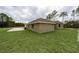 A view of the backyard with a concrete pad and lawn at 12217 Sw 67Th Ln, Ocala, FL 34481