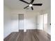 Spacious bedroom with a ceiling fan, closet, and a modern interior door at 12217 Sw 67Th Ln, Ocala, FL 34481