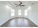 Open bedroom area with natural light, wood-look flooring, and ceiling fan at 12217 Sw 67Th Ln, Ocala, FL 34481