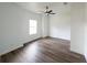 Bright bedroom features new dark wood-look flooring, ceiling fan, and ample natural light at 12217 Sw 67Th Ln, Ocala, FL 34481