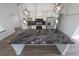 A black and white kitchen island with black marble countertop at 12217 Sw 67Th Ln, Ocala, FL 34481