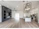 Spacious living room with modern lighting, vinyl plank flooring, and an open layout flowing into the kitchen at 12217 Sw 67Th Ln, Ocala, FL 34481