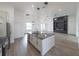 Modern kitchen island and open-concept living room with laminate flooring at 12217 Sw 67Th Ln, Ocala, FL 34481