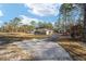 House with a gravel driveway and detached shop at 13700 Sw 71St Ln, Ocala, FL 34481